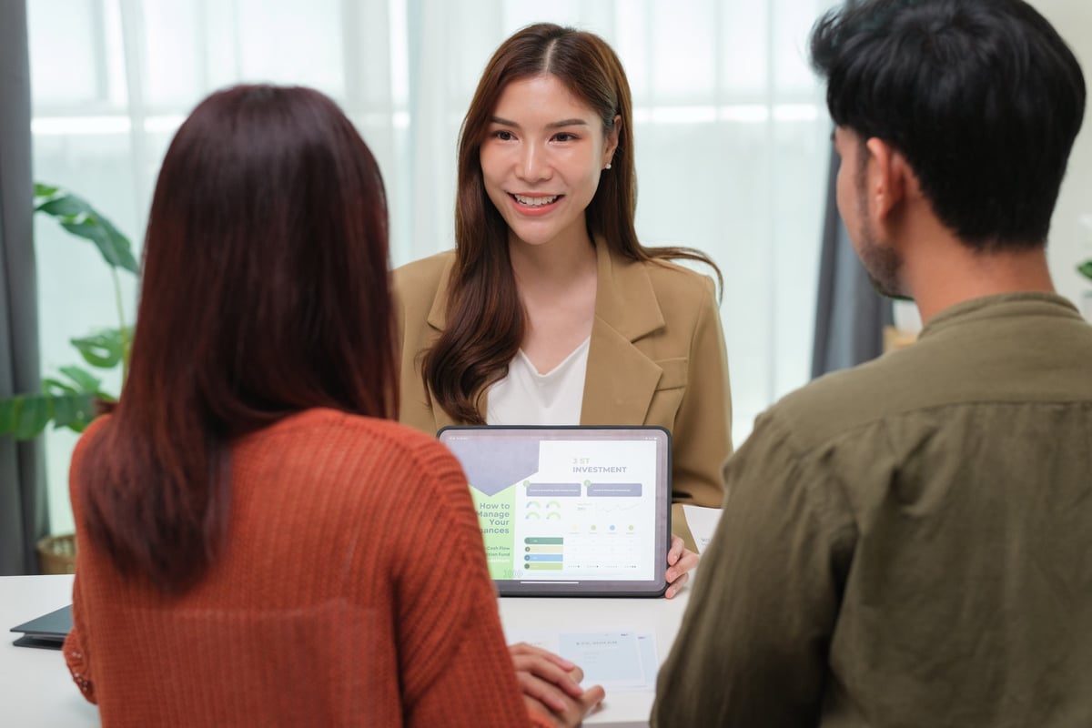 Financial advisor consulting clients during a client meeting to discuss personal finance planning, wealth management, mortgage, loan options, and investment portfolio decisions